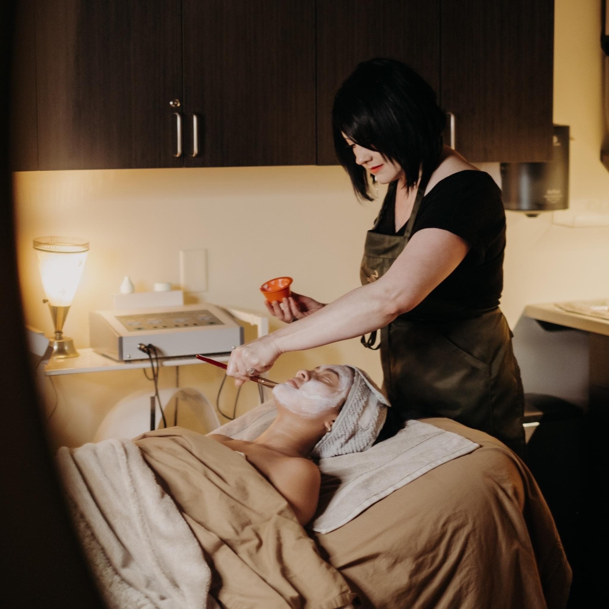 Erin performing a facial treatment